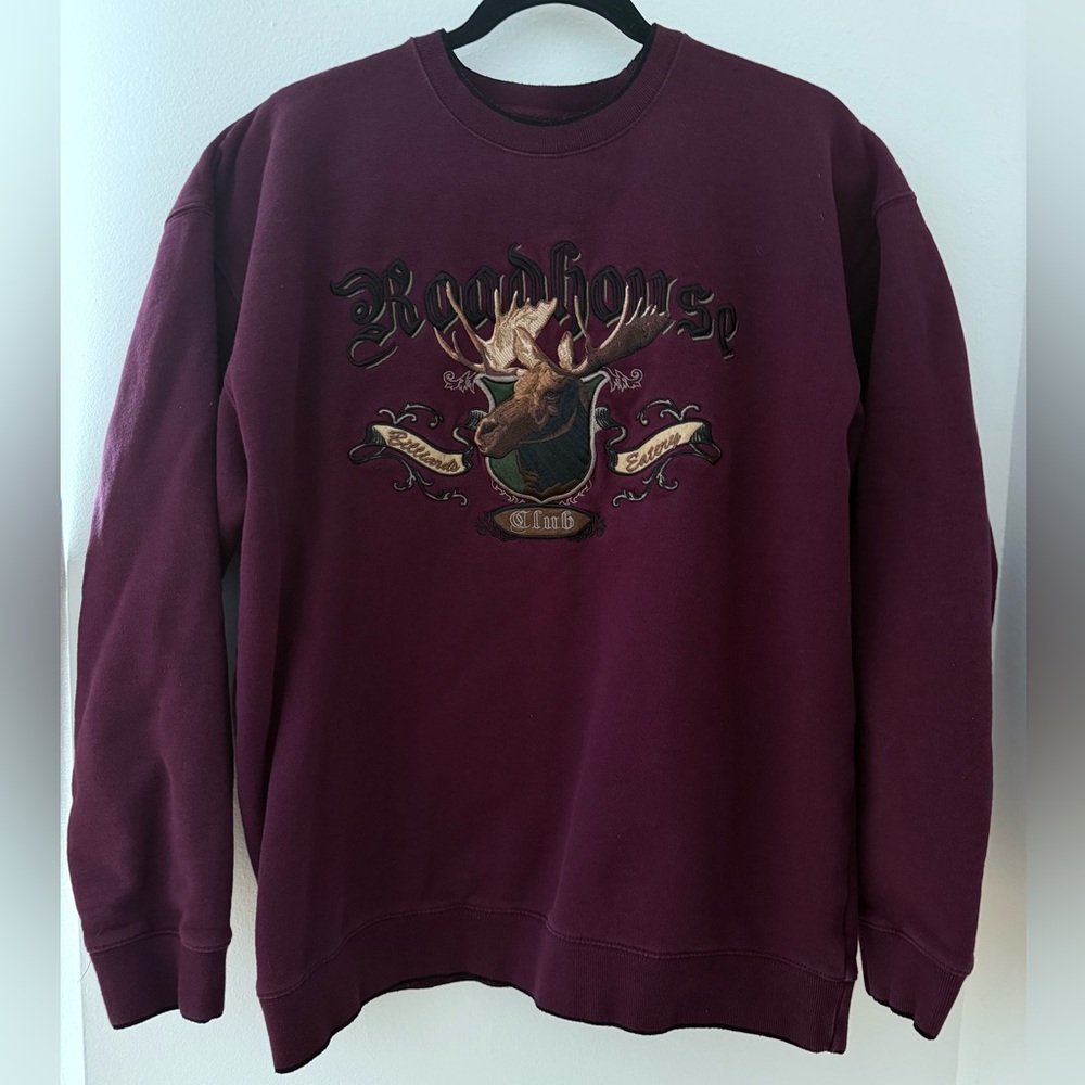 Maroon fleece crewneck sweatshirt with moose embroidery.
